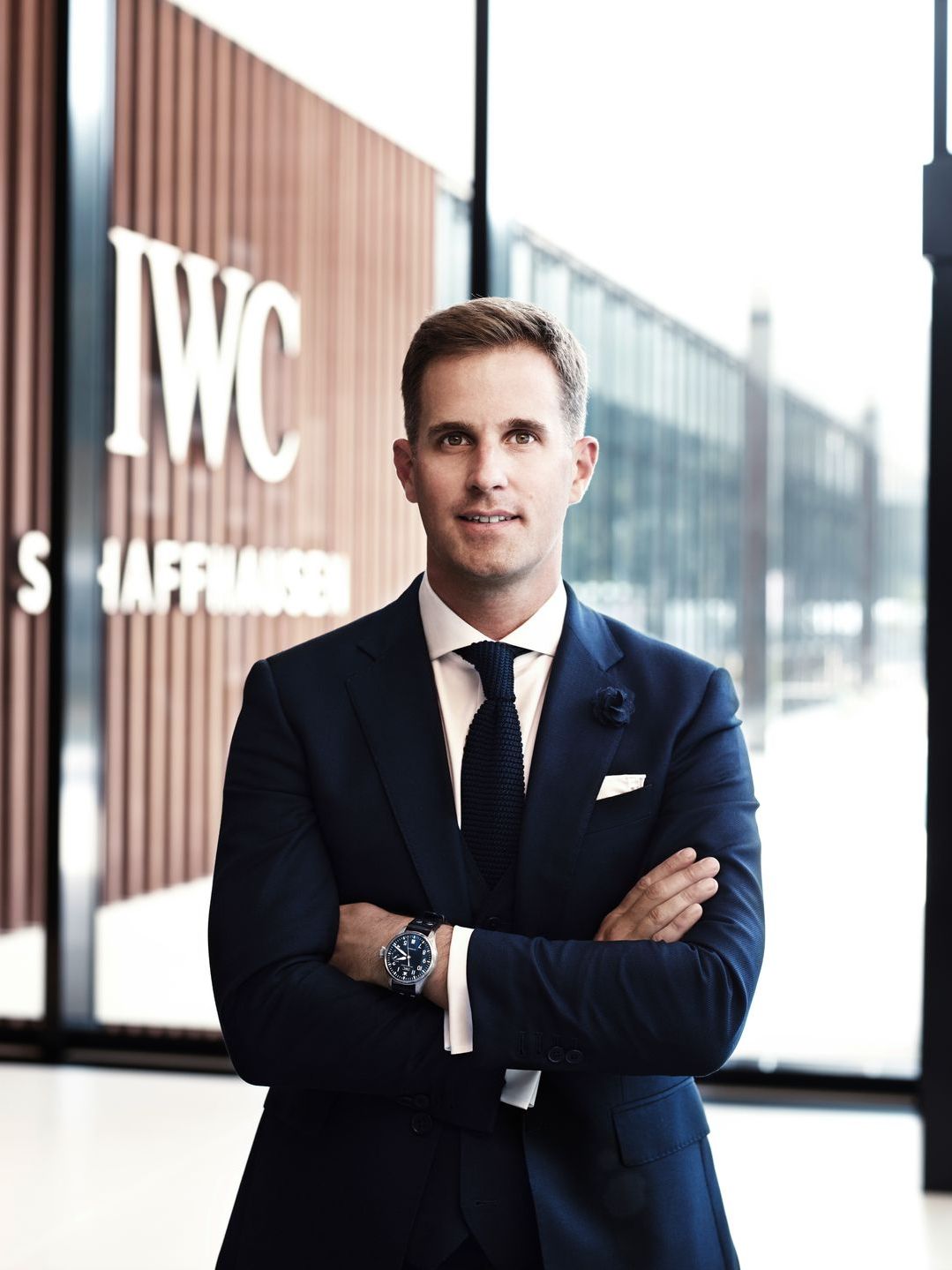 Christoph Grainger-Herr, CEO in a suit in front of an IWC building