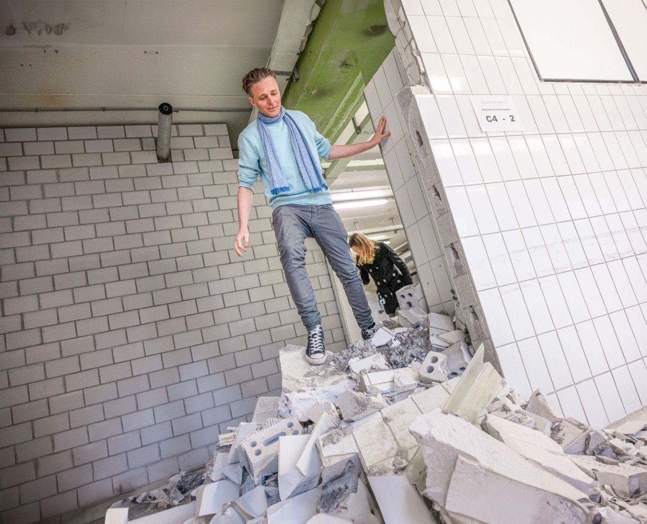 A man is standing on top of a pile of bricks