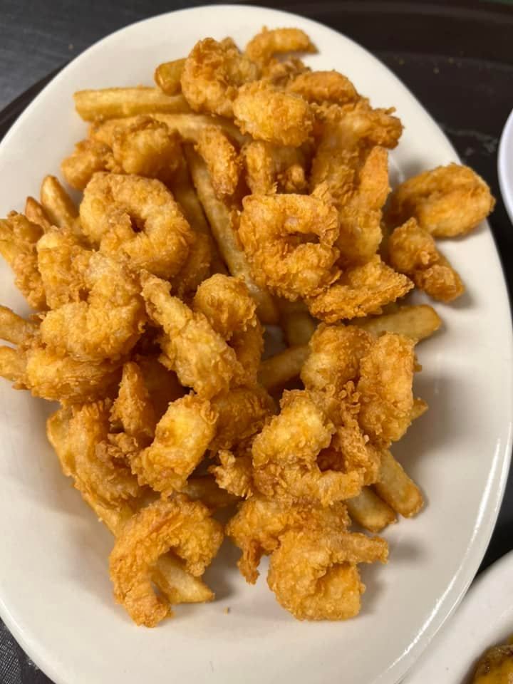 Plate of golden fried strips on a white dish, viewed from above.