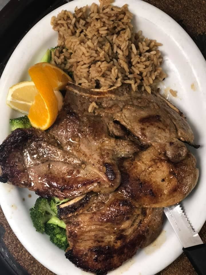 Plate with grilled chicken, rice, broccoli, and orange slices.