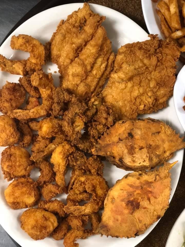 Plate of assorted fried seafood and fish fillets on a white dish