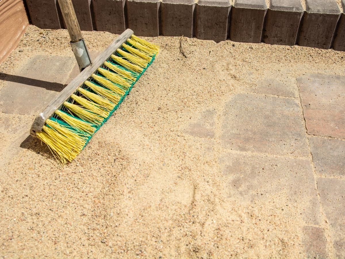 brushing in sand into a  block paving pathway