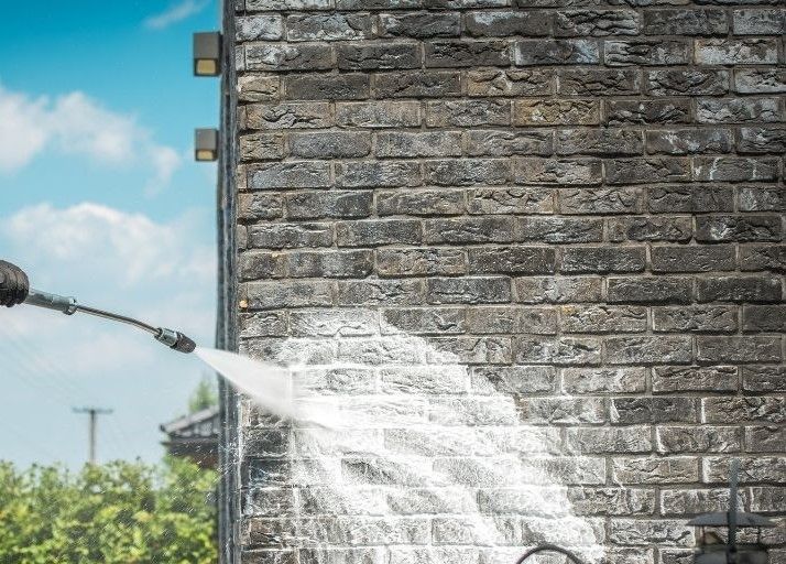 cleaning a grey brick wall in Bradford