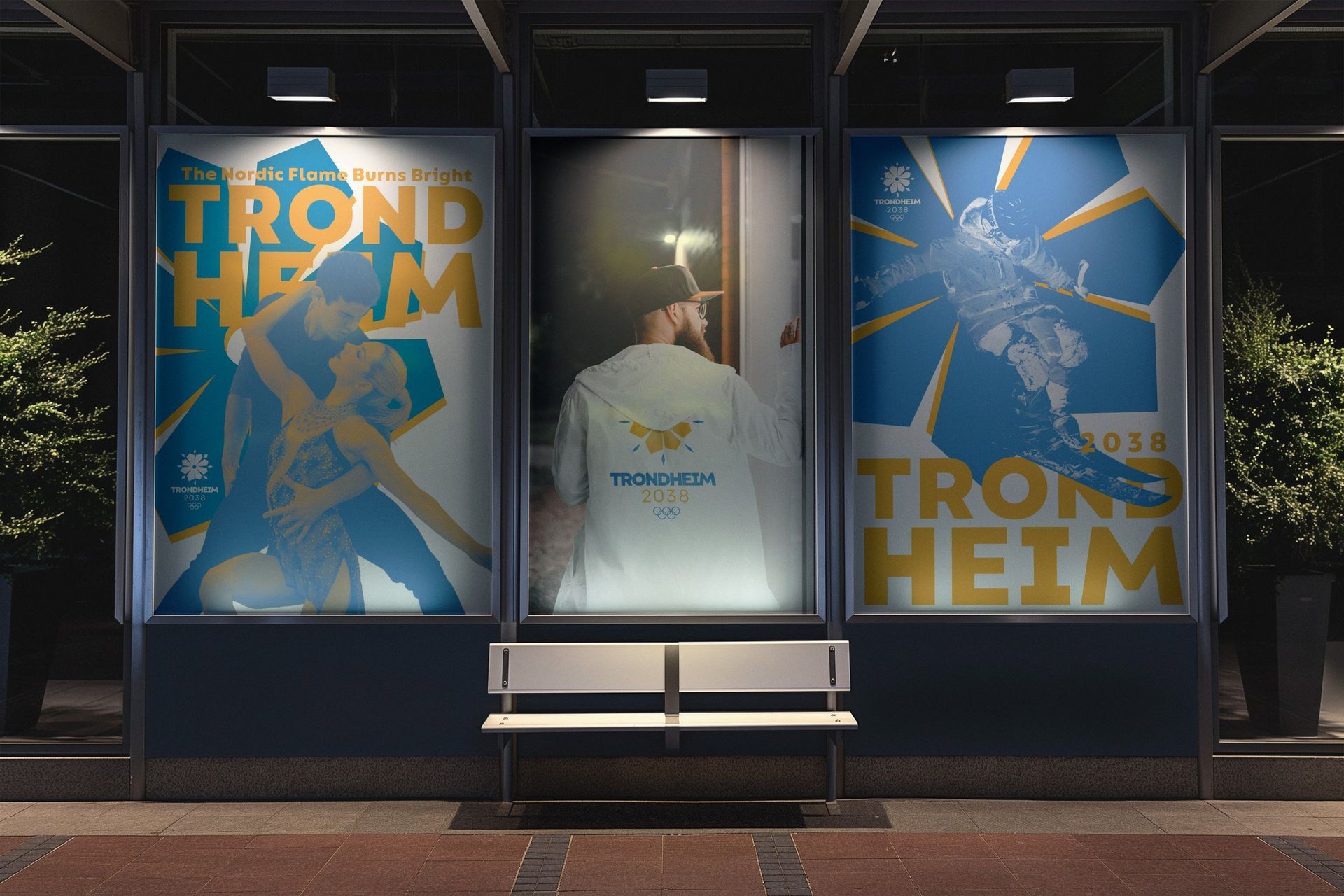 Storefront window with three blue Trondheim-themed posters and a white jacket displayed on a bench