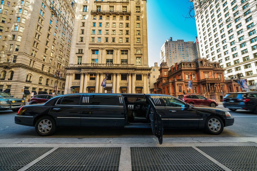A Black Limousine Is Parked In A Parking Lot In Front Of A Building — Métier Medical Ltd in USA