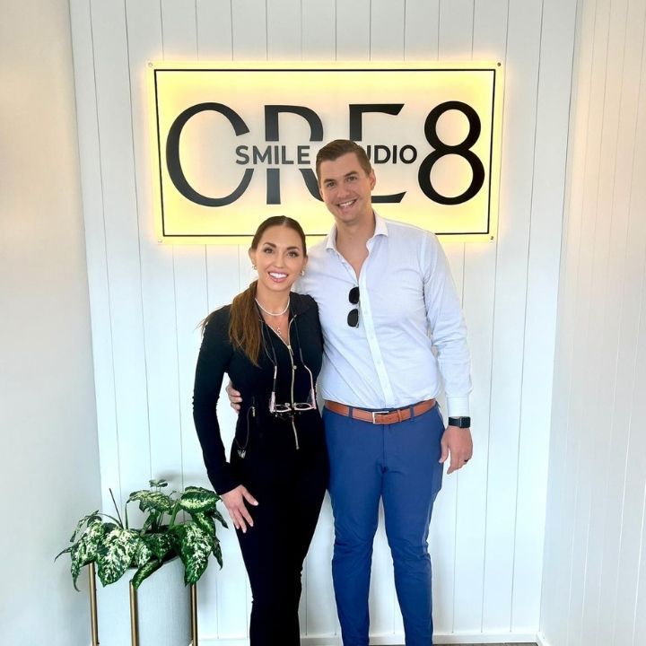 Two people standing in front of a glowing 