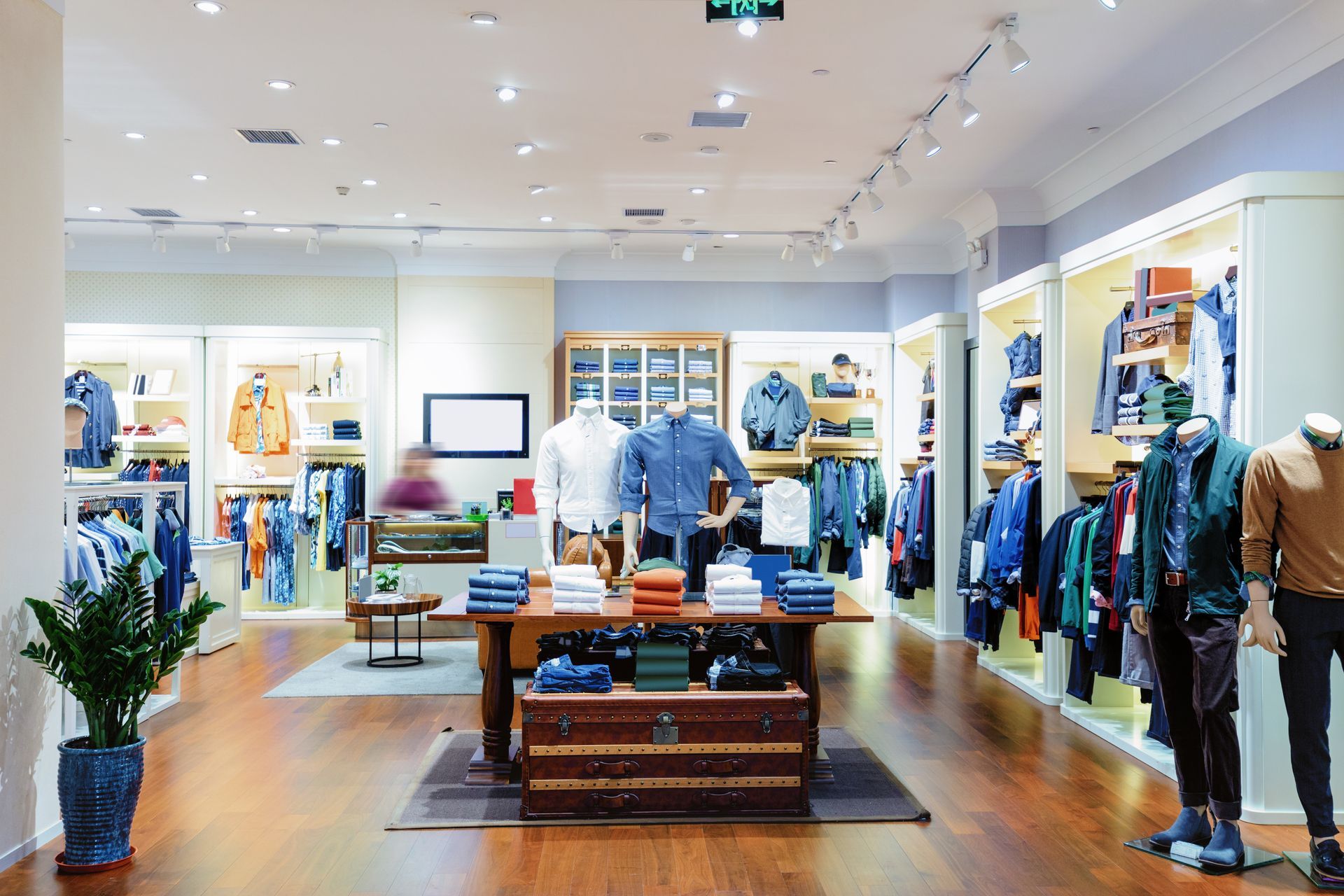 A clothing store filled with lots of clothes and mannequins.