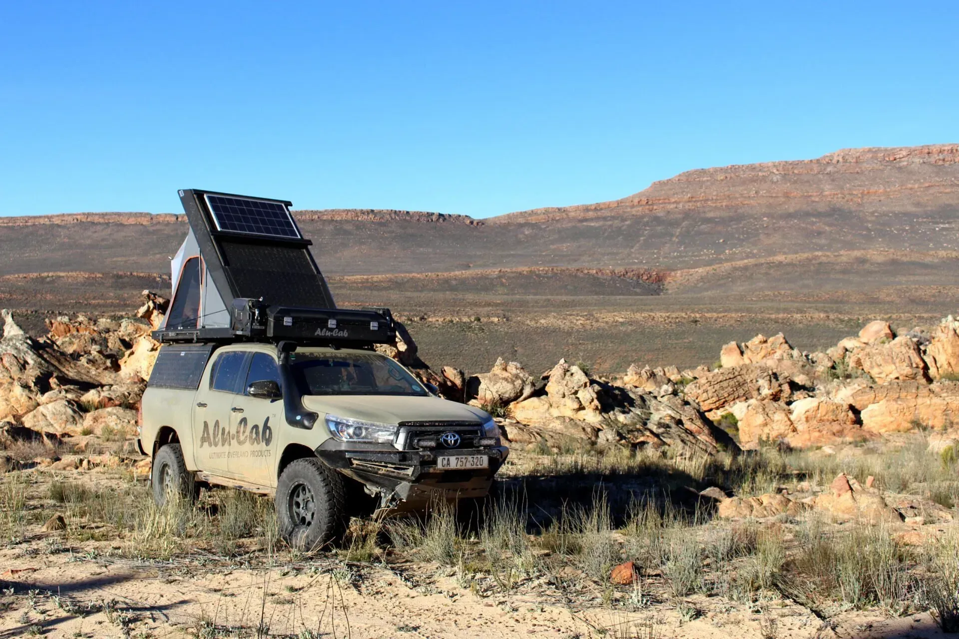 A Truck With a Tent on Top of It is Parked in the Desert — Whitsunday 4x4 & Automotive In Cannonvale, QLD