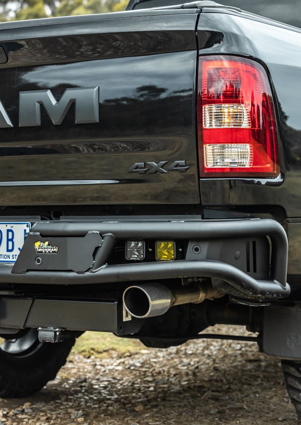 A Black Ram Truck With a Rear Bumper is Parked in the Dirt — Whitsunday 4x4 & Automotive In Bowen, QLD