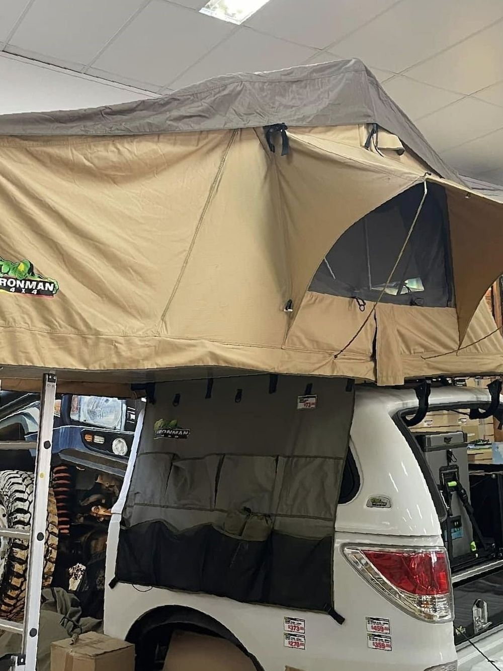 A Tent is Sitting on Top of a White SUV — Whitsunday 4x4 & Automotive In Proserpine, QLD