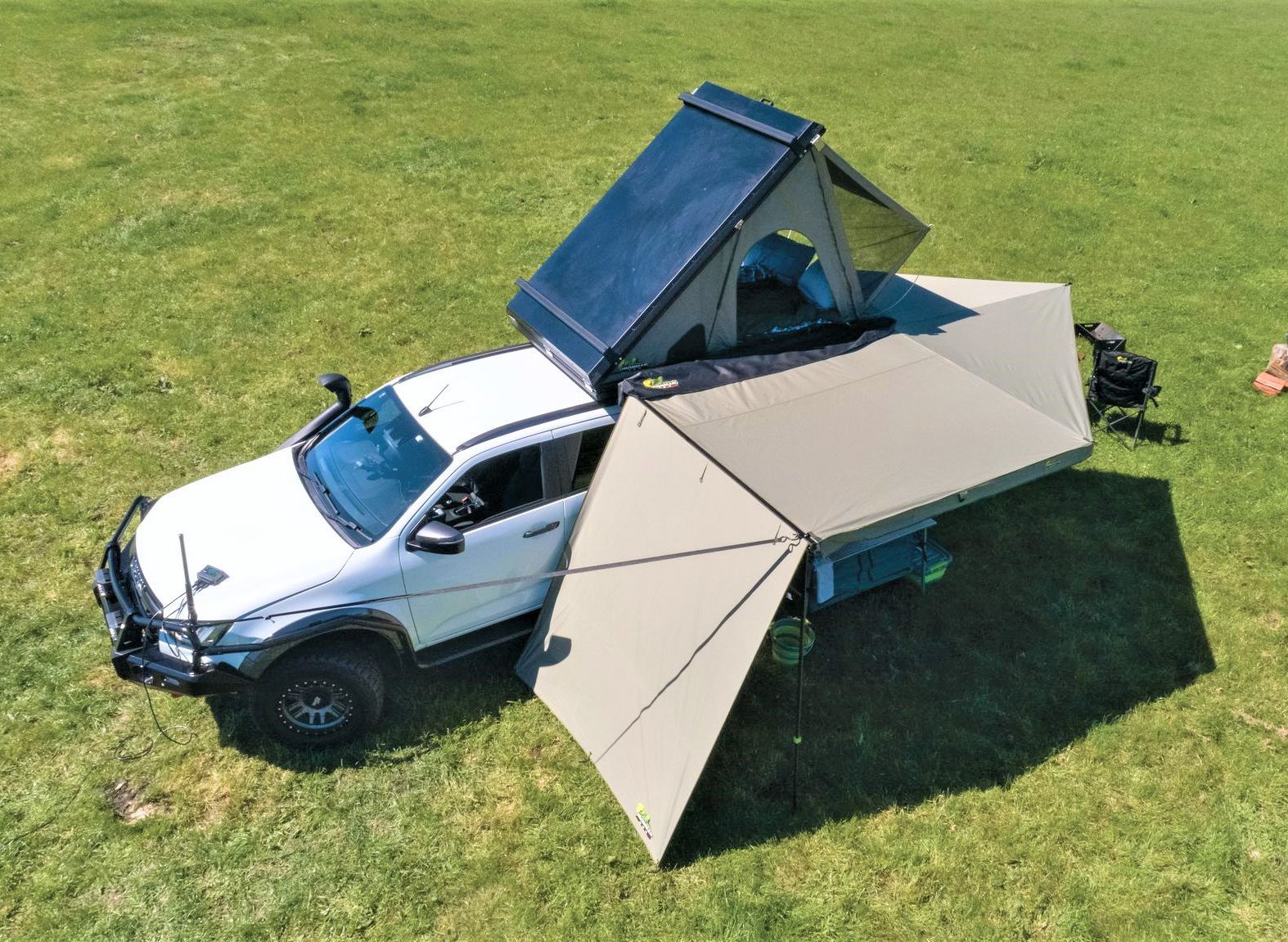White pickup truck with pop-up camping tent setup on a grassy field — Whitsunday 4x4 & Automotive In Proserpine, QLD