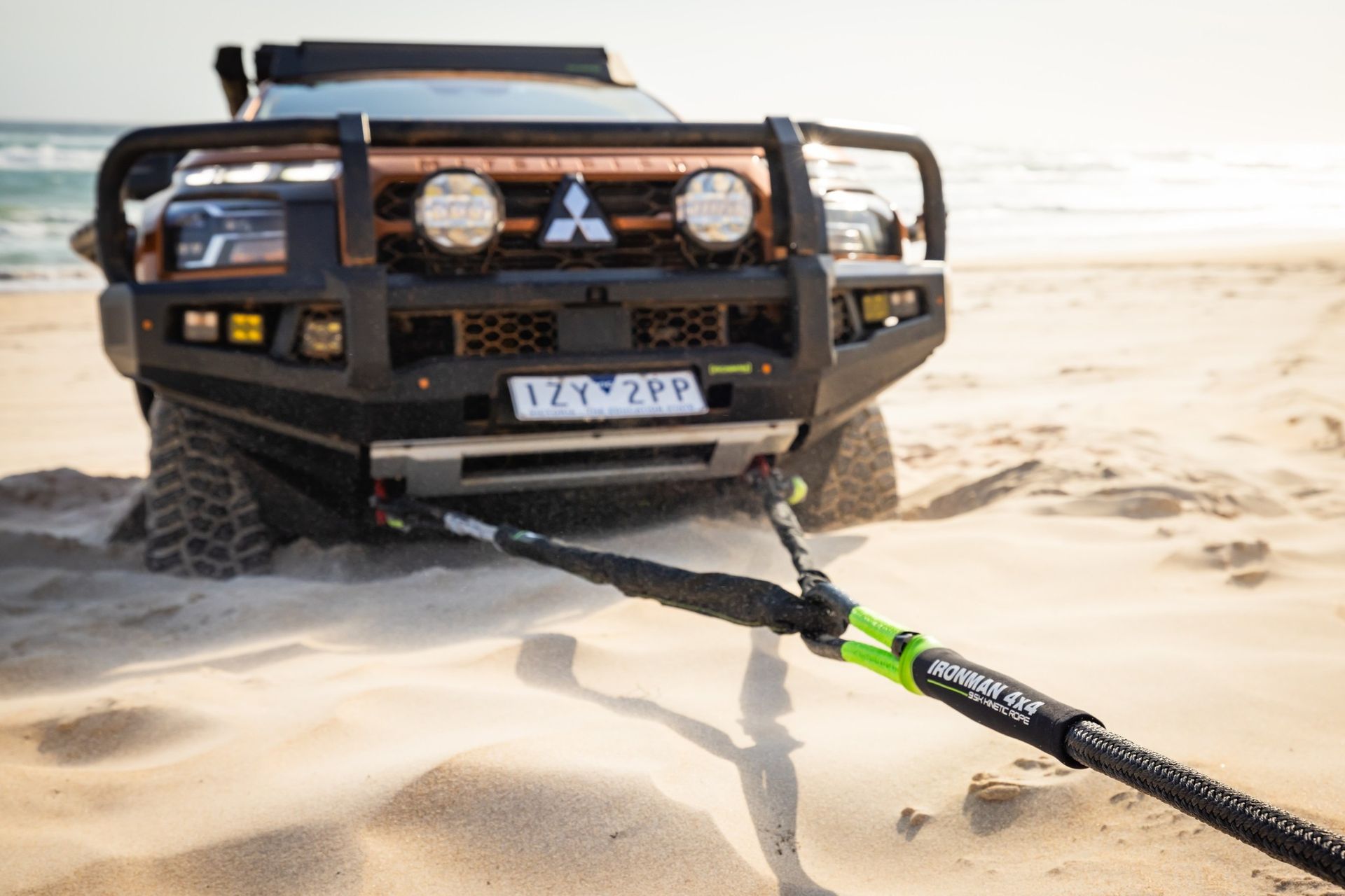 4x4 SUV stuck in sand, towing recovery strap attached on a beach — Whitsunday 4x4 & Automotive In Proserpine, QLD