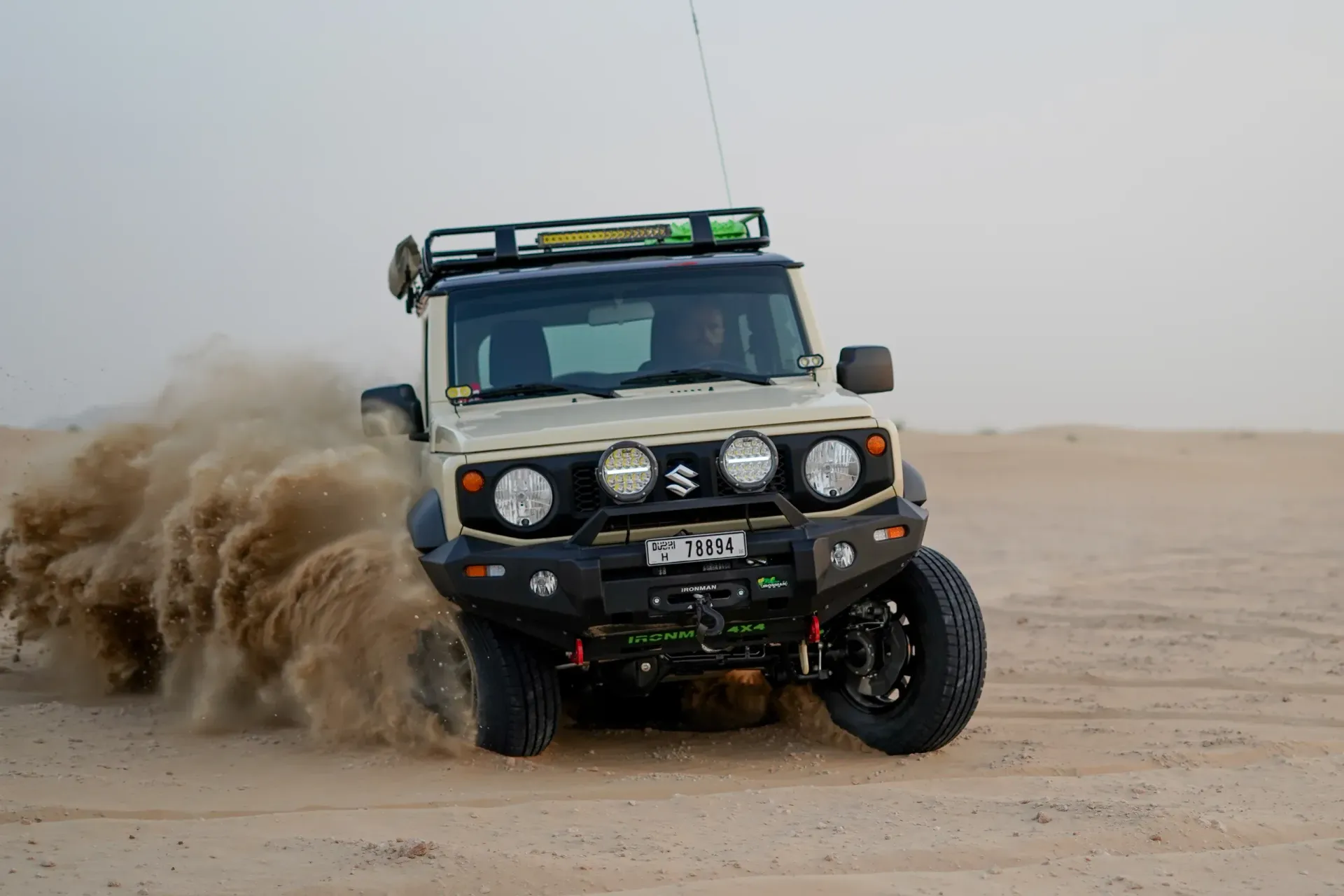 Off-road SUV racing through desert sand, kicking up a large plume of dust — Whitsunday 4x4 & Automotive In Proserpine, QLD