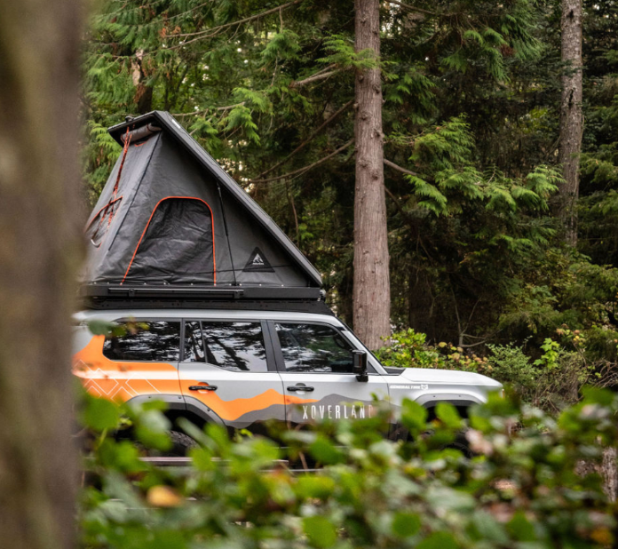 A Car with a Tent on Top of it in the Woods - Whitsunday 4x4 & Automotive In Cannonvale, QLD