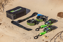 A set of tie down straps and a case are sitting on top of a sandy beach - Whitsunday 4x4 & Automotive In Cannonvale, QLD