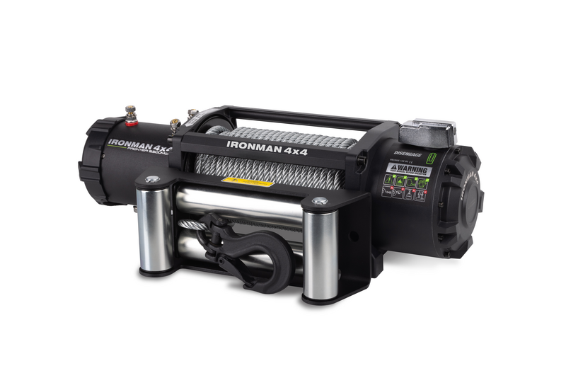 A black winch is sitting on a white surface.