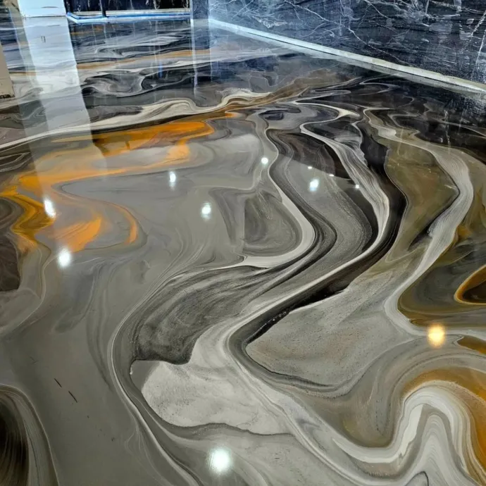 Swirling gray, white, and amber marble-like floor reflecting overhead lights in a glossy interior.