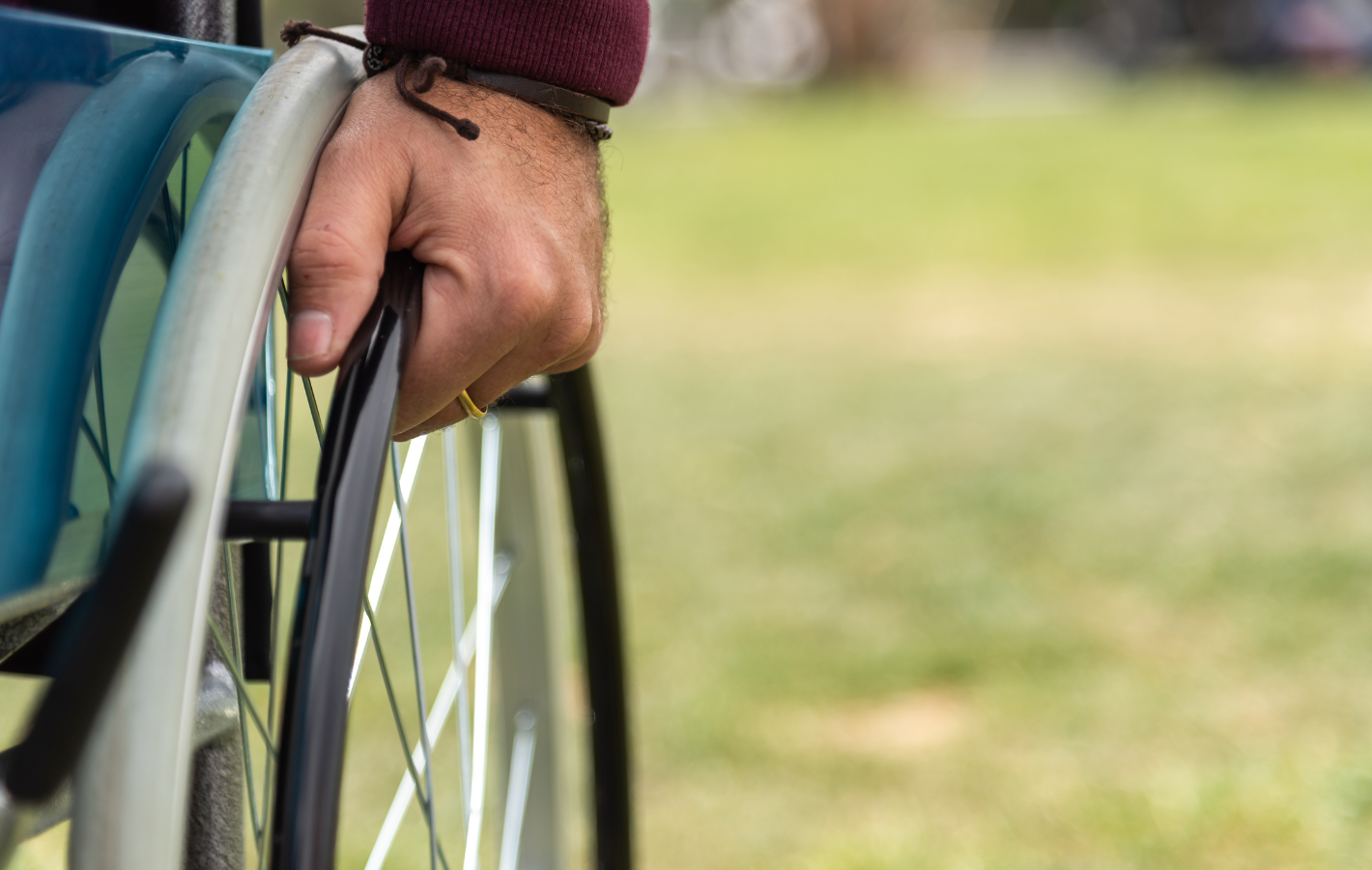 A person in a wheelchair is holding the wheel.