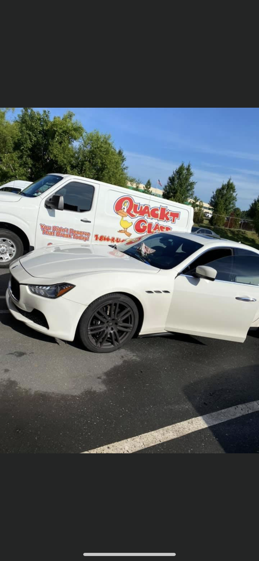 White Maserati car parked in front of a white 