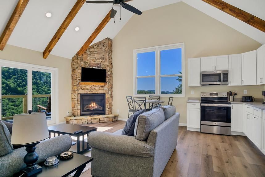 A living room with a fireplace and a ceiling fan