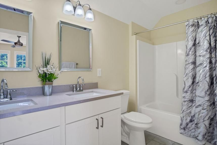 A bathroom with a sink , toilet , and shower.