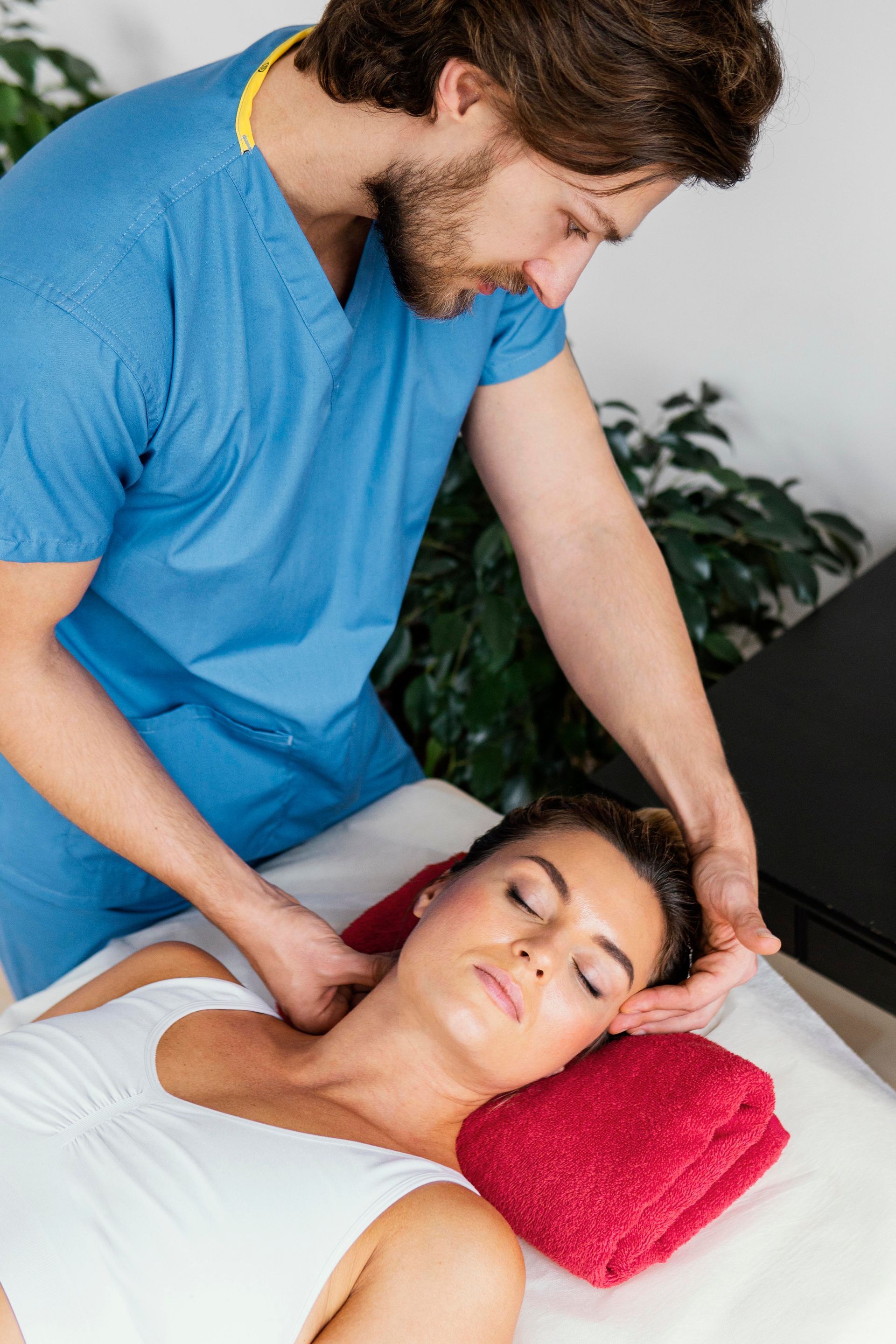 physiotherapist checking patient's neck