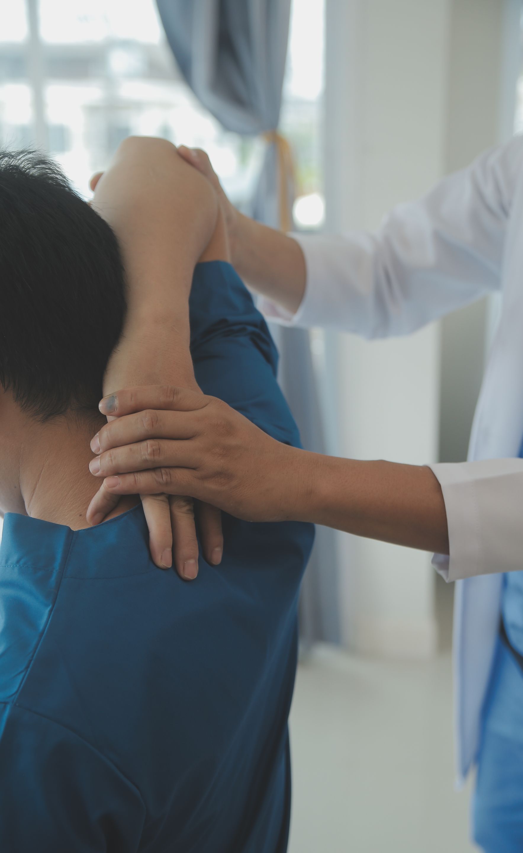 physiotherapist working with patient