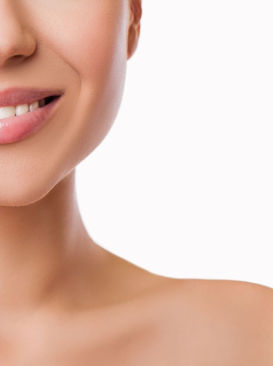 Smiling woman, shoulder exposed, against a white background.