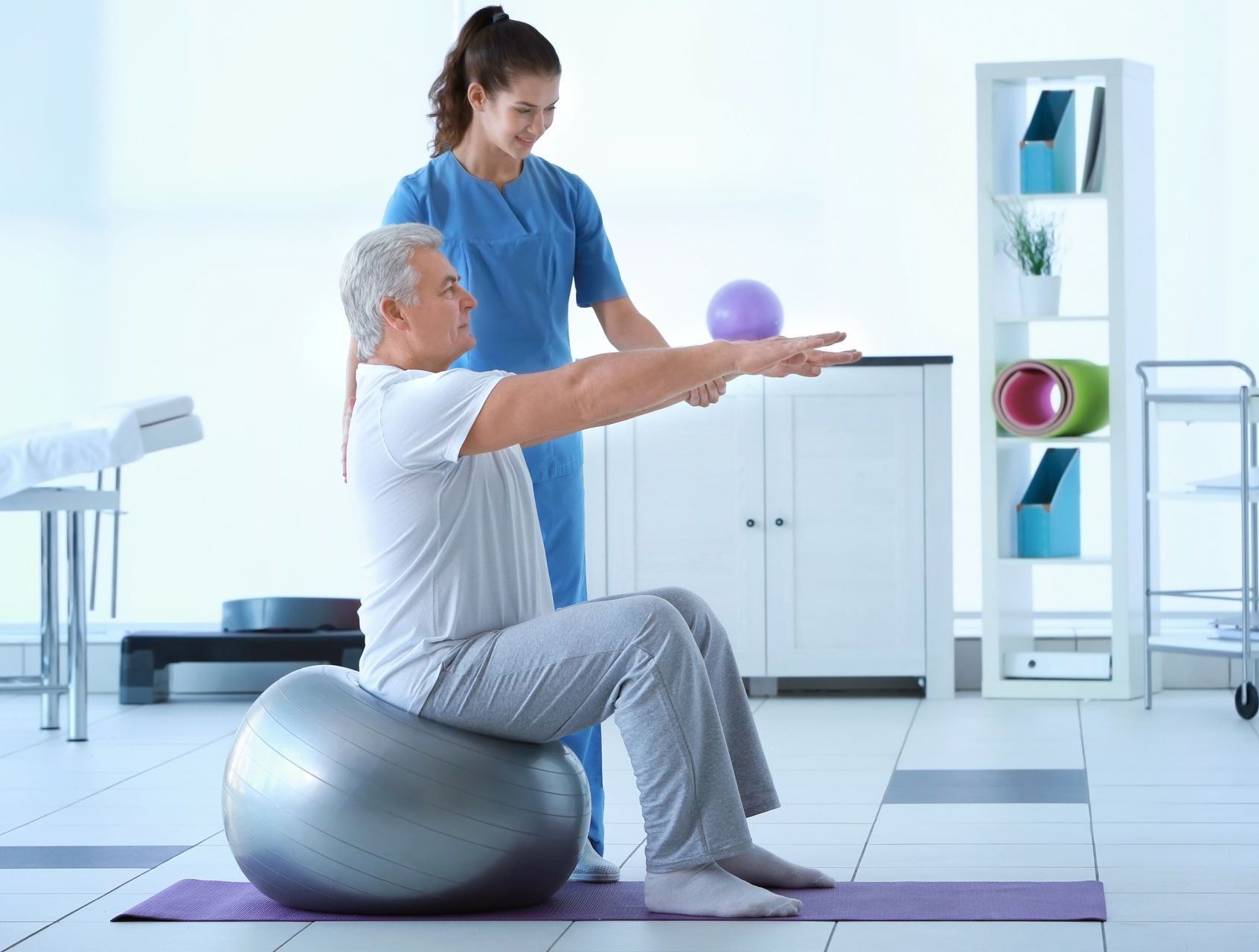 man balancing on exercise ball
