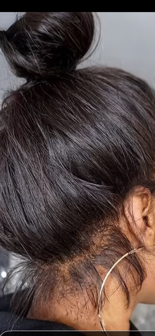 Close-up of a dark-haired person’s bun hairstyle and ear with a hoop earring