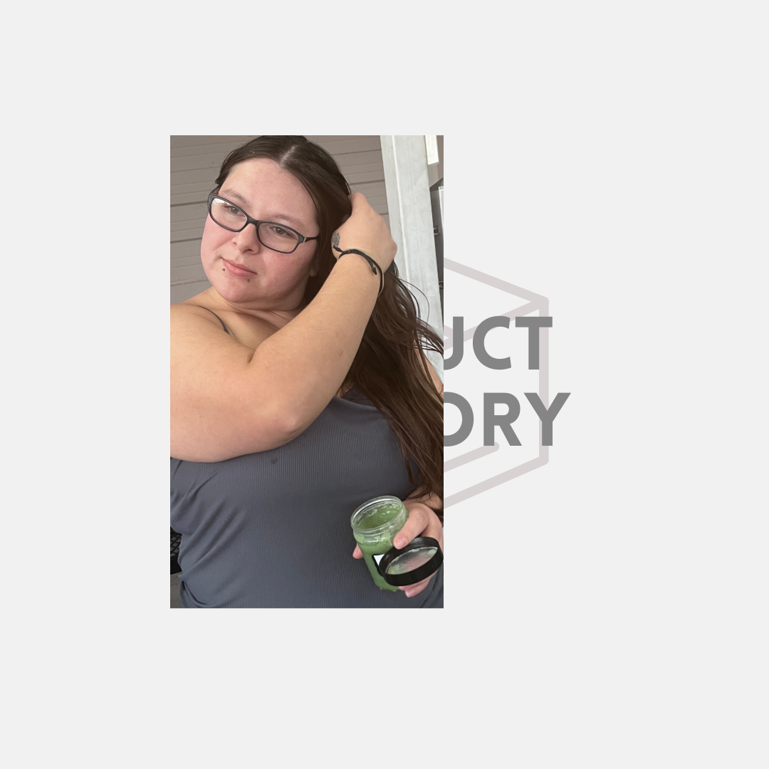 Woman with glasses adjusting her hair while holding a green drink, in front of partial text.