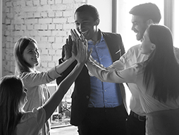 A group of people are giving each other a high five.