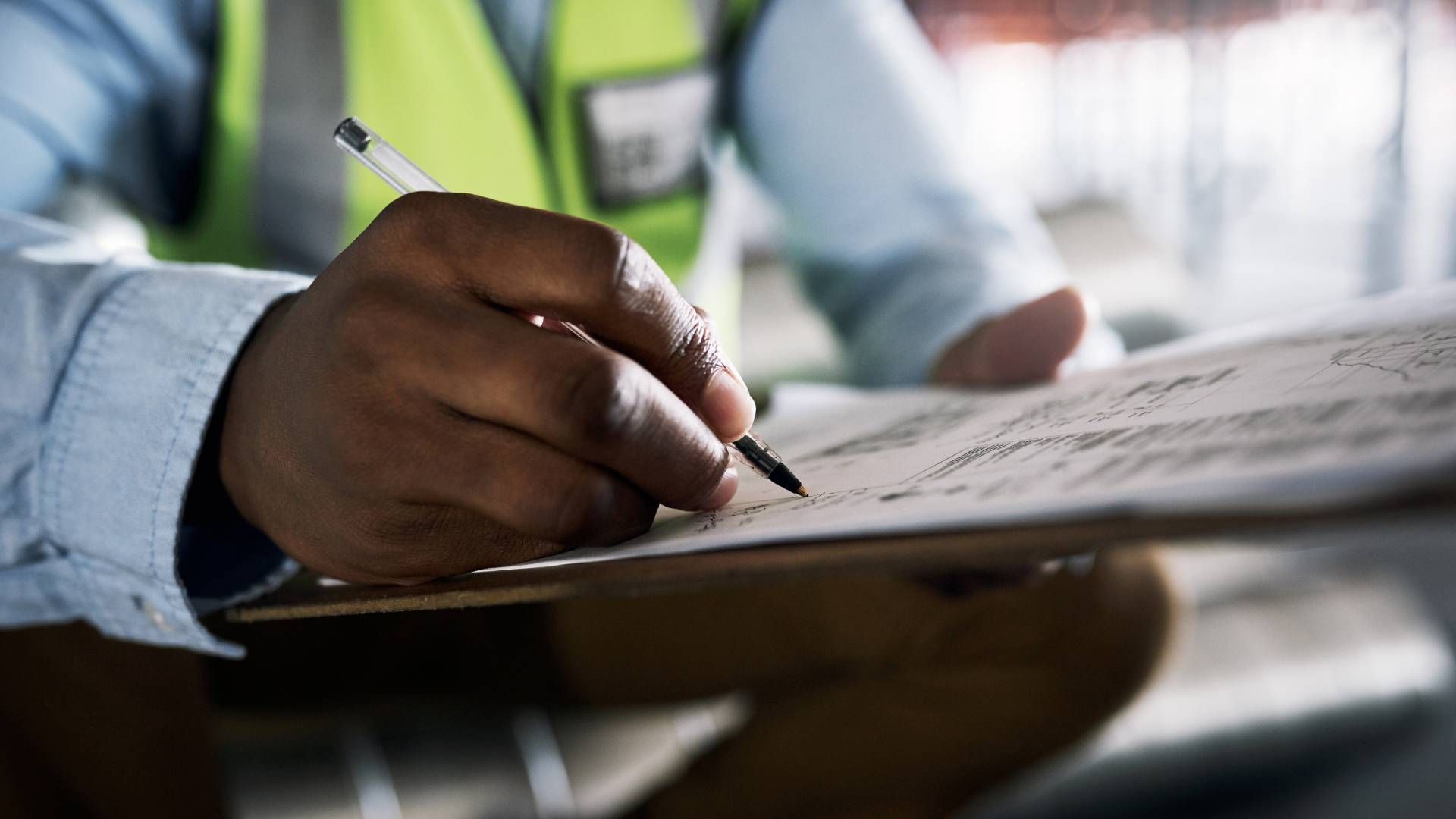 A radon tester writes notes for a radon mitigation system near Lexington, KY