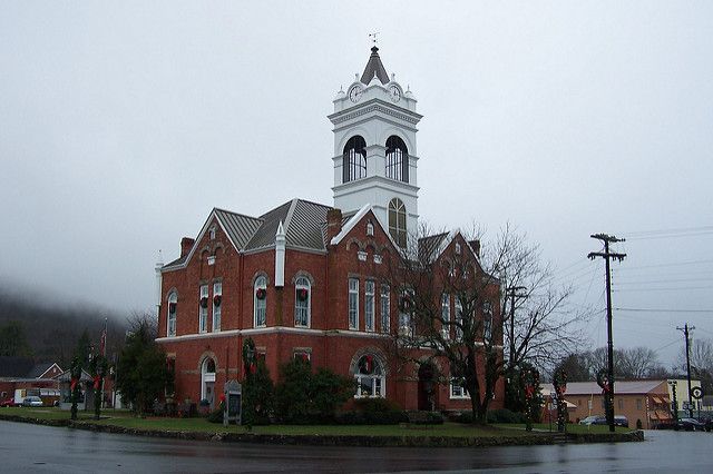 A large brick building with a white tower on top