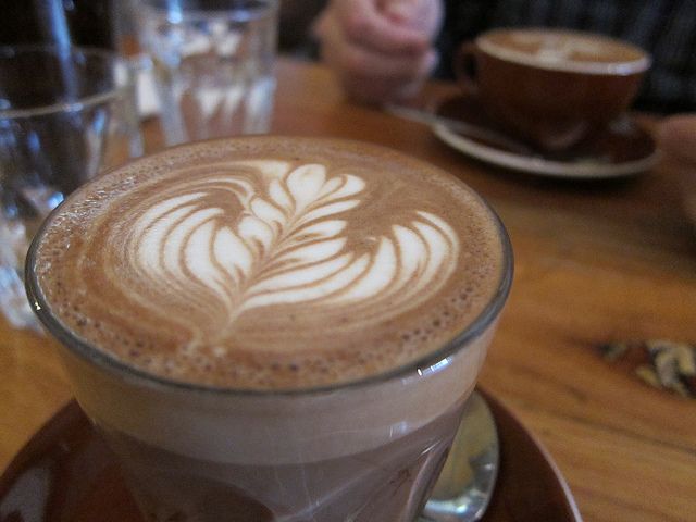 A close up of a cup of cappuccino on a saucer