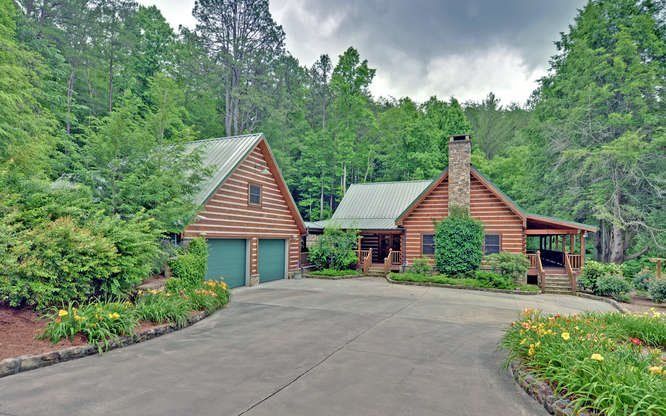 A large log cabin in the middle of a forest
