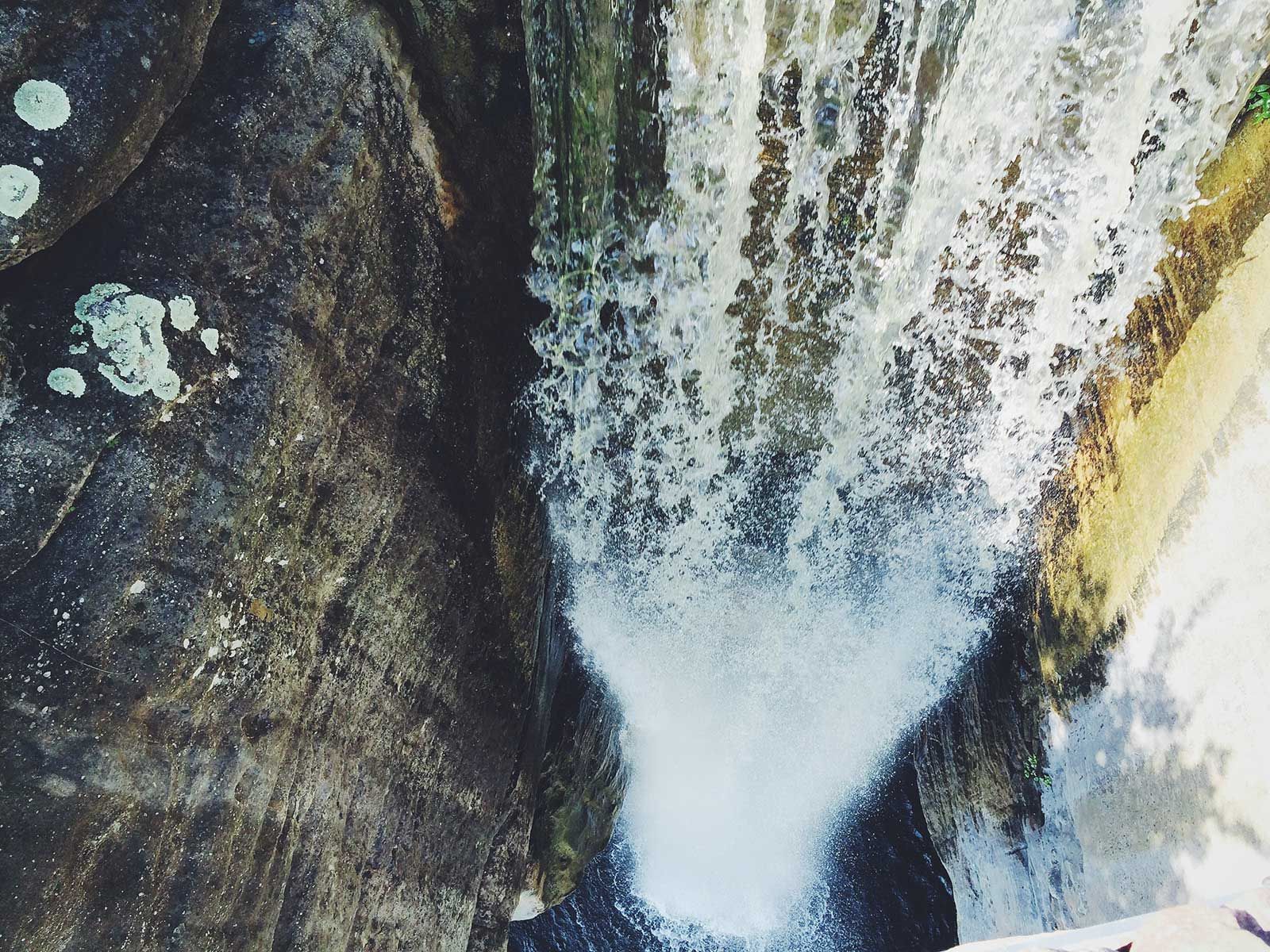 A waterfall is coming down a rocky cliff