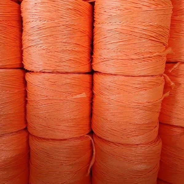 Un montón de rollos de hilo naranja se apilan uno encima del otro.