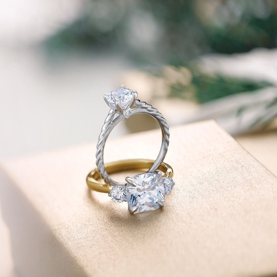 Two rings are sitting on top of each other on a box.