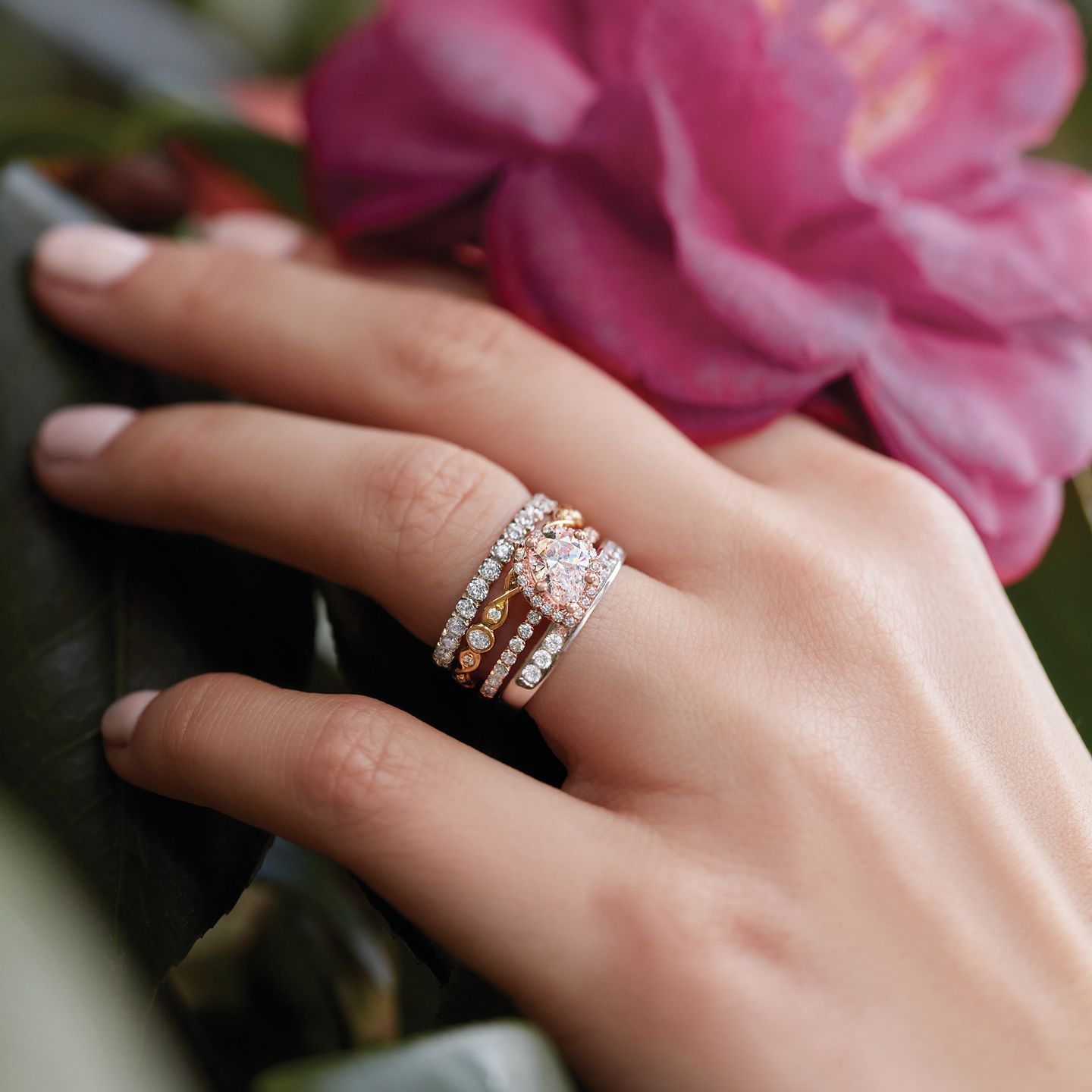 A close up of a woman 's hand with rings on it