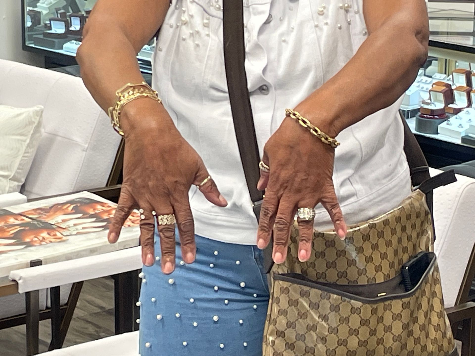A woman wearing a purse and a bracelet on her wrist