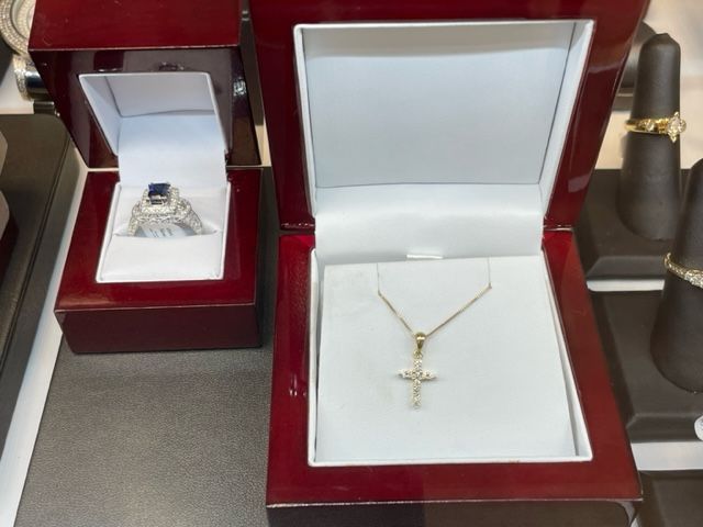 A necklace in a box next to a ring