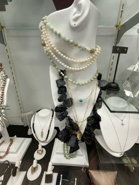 A display of necklaces on a mannequin in a store