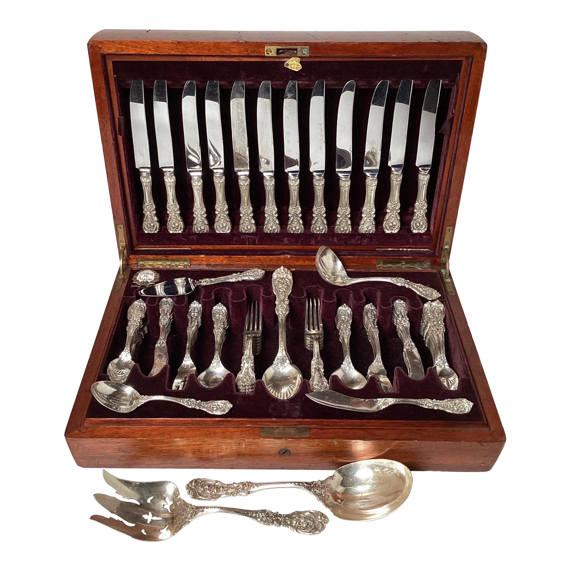 A wooden box filled with silverware including knives forks and spoons