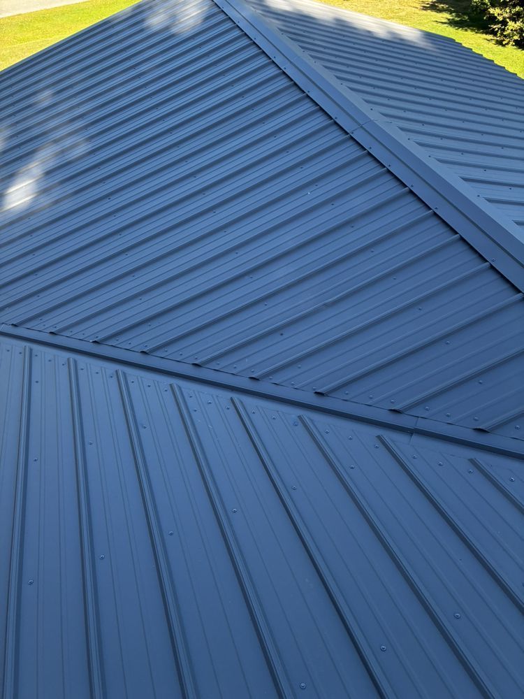 Blue corrugated metal roof with intersecting seams and ridged panels