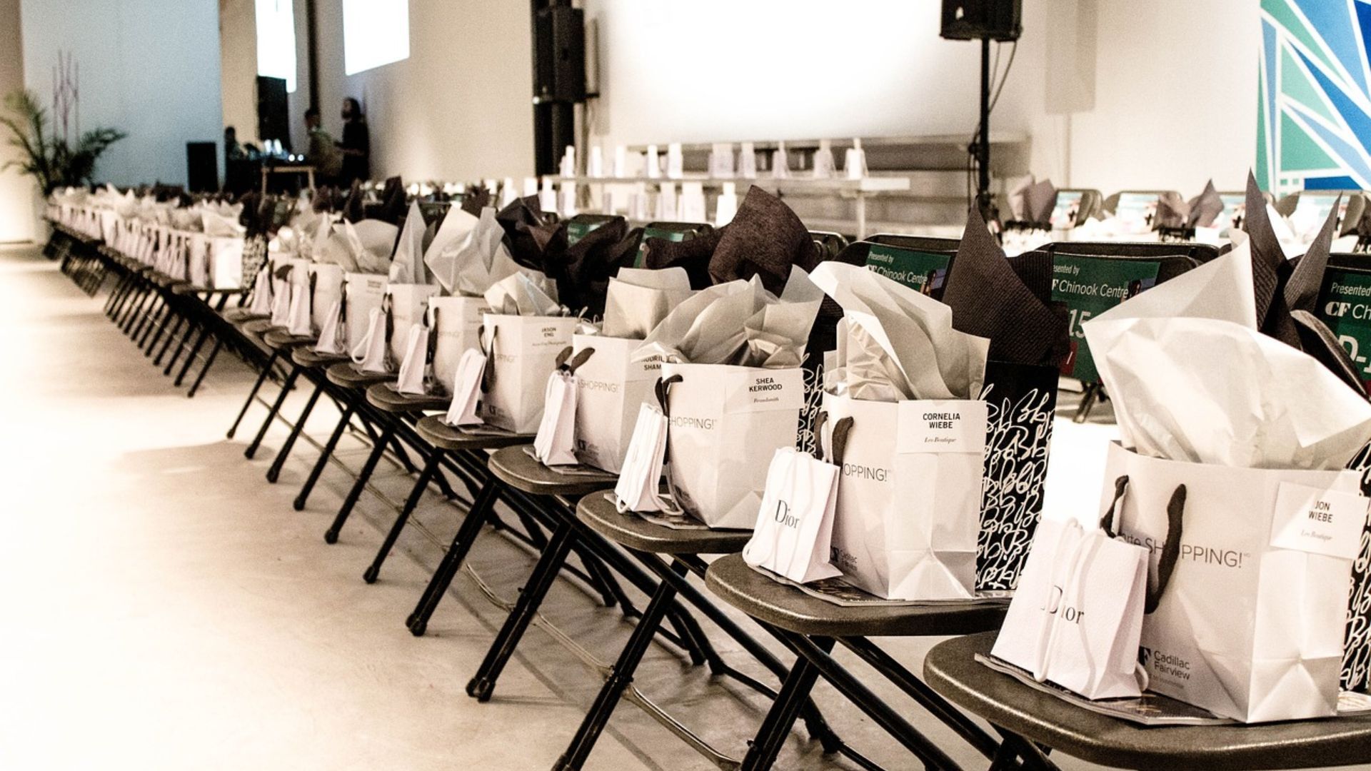 A long row of folding chairs filled with bags and tissues.