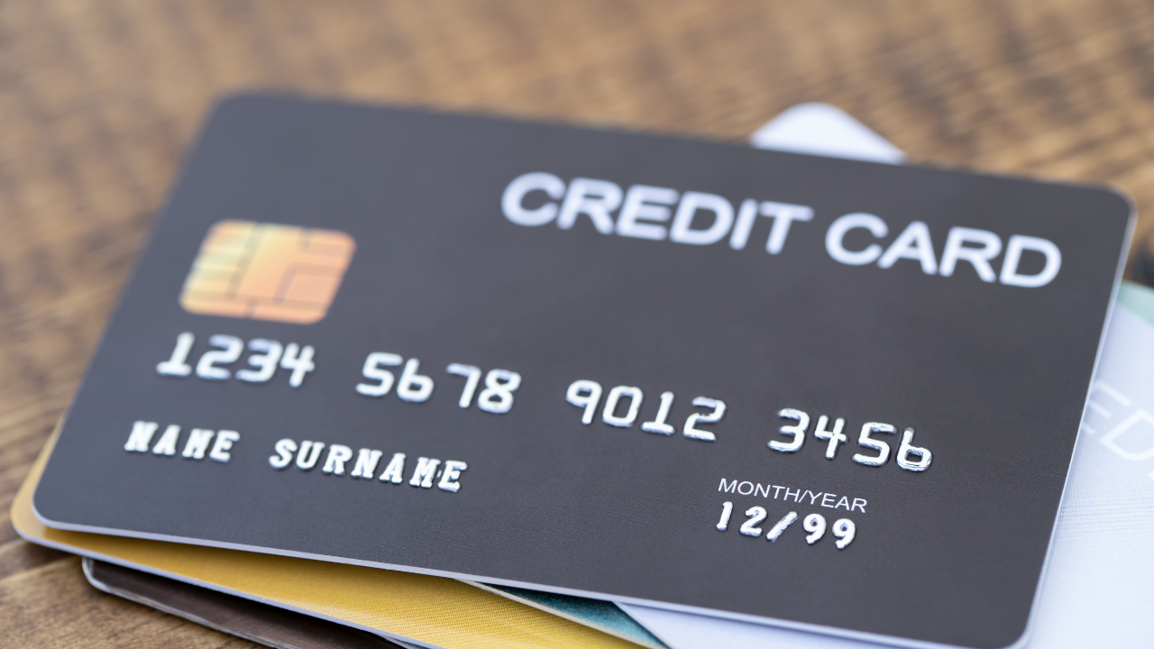 A black credit card with the numbers 1234 5678 9012 3456 on it