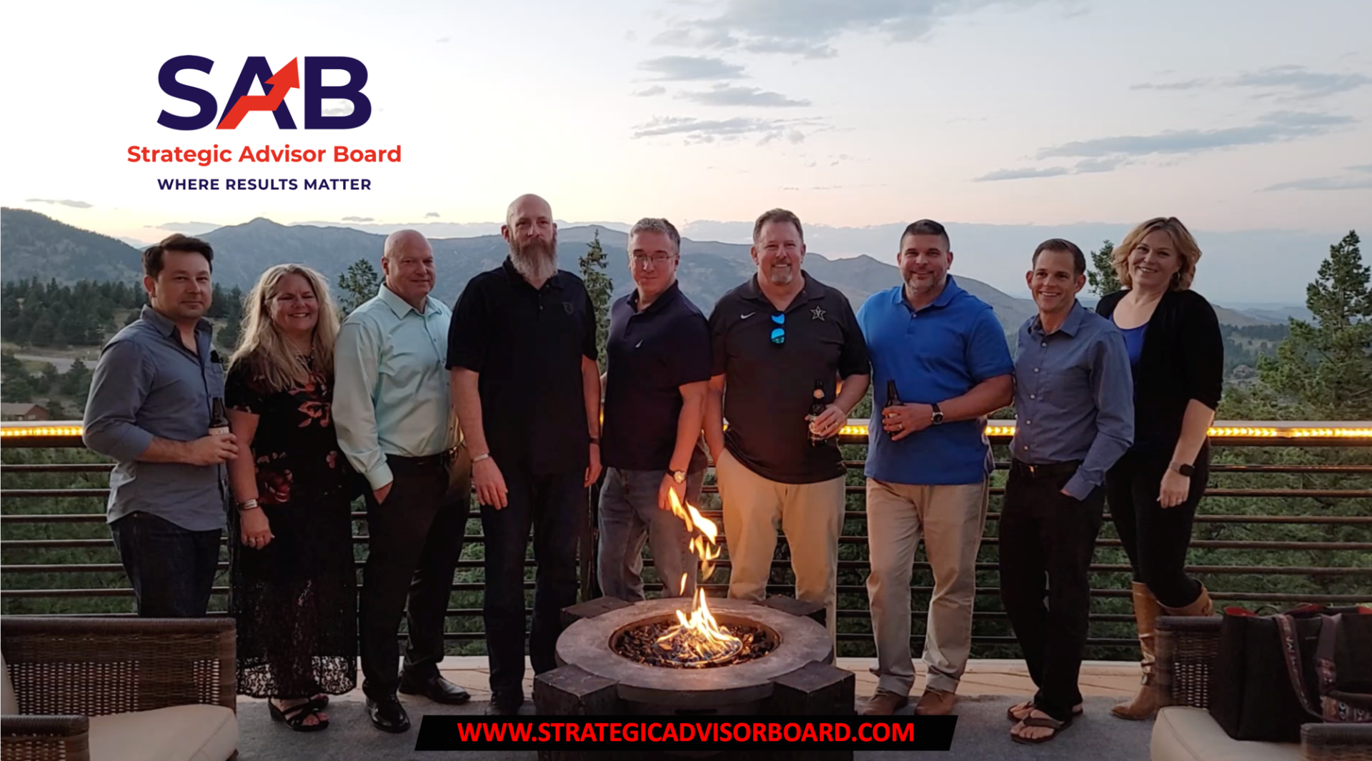 A group of people are standing around a fire pit.