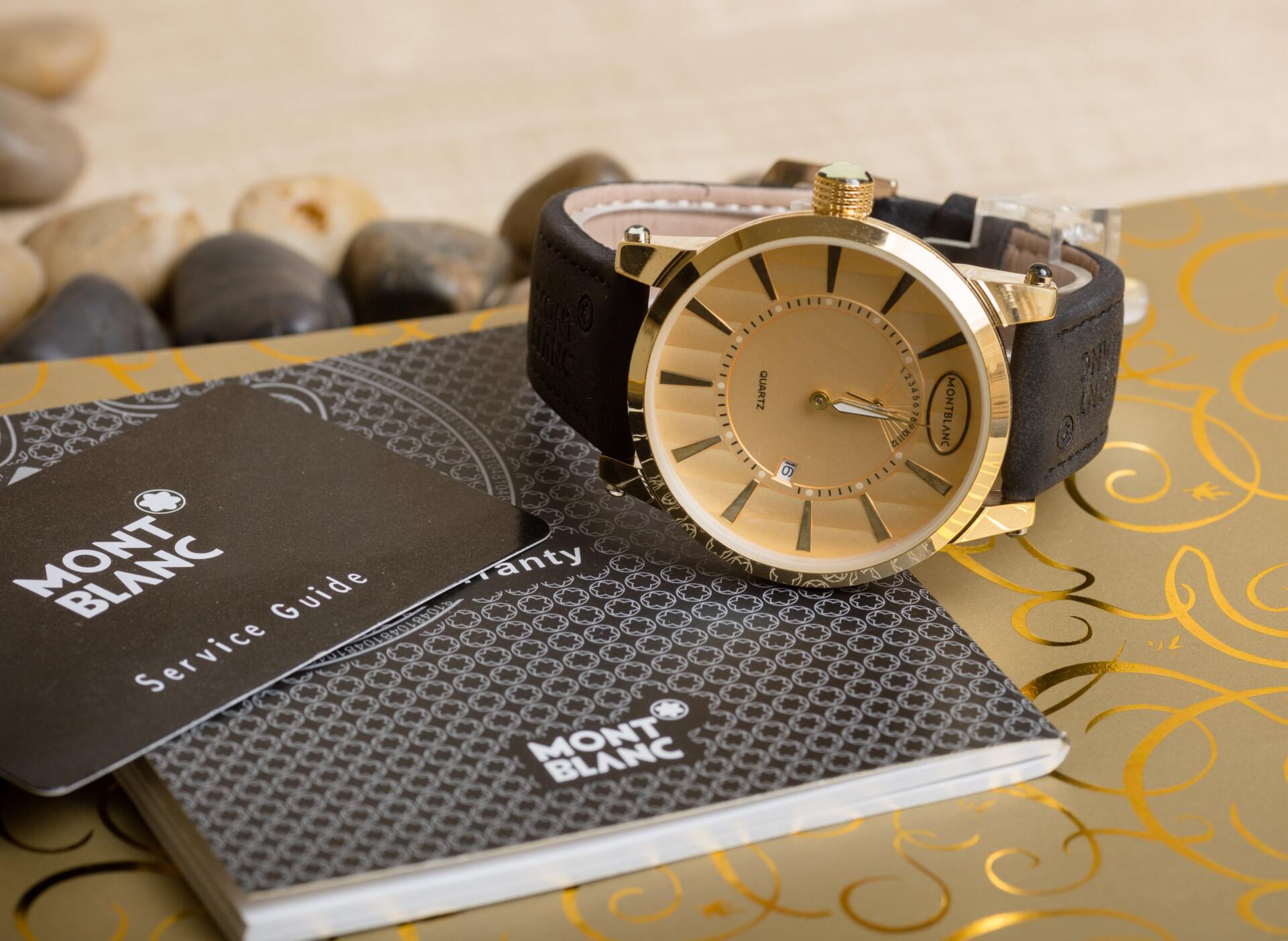 A mont blanc watch is sitting on top of a service guide