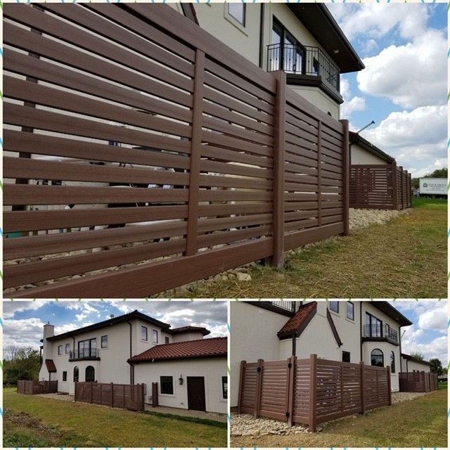 A white house with a wooden fence around it